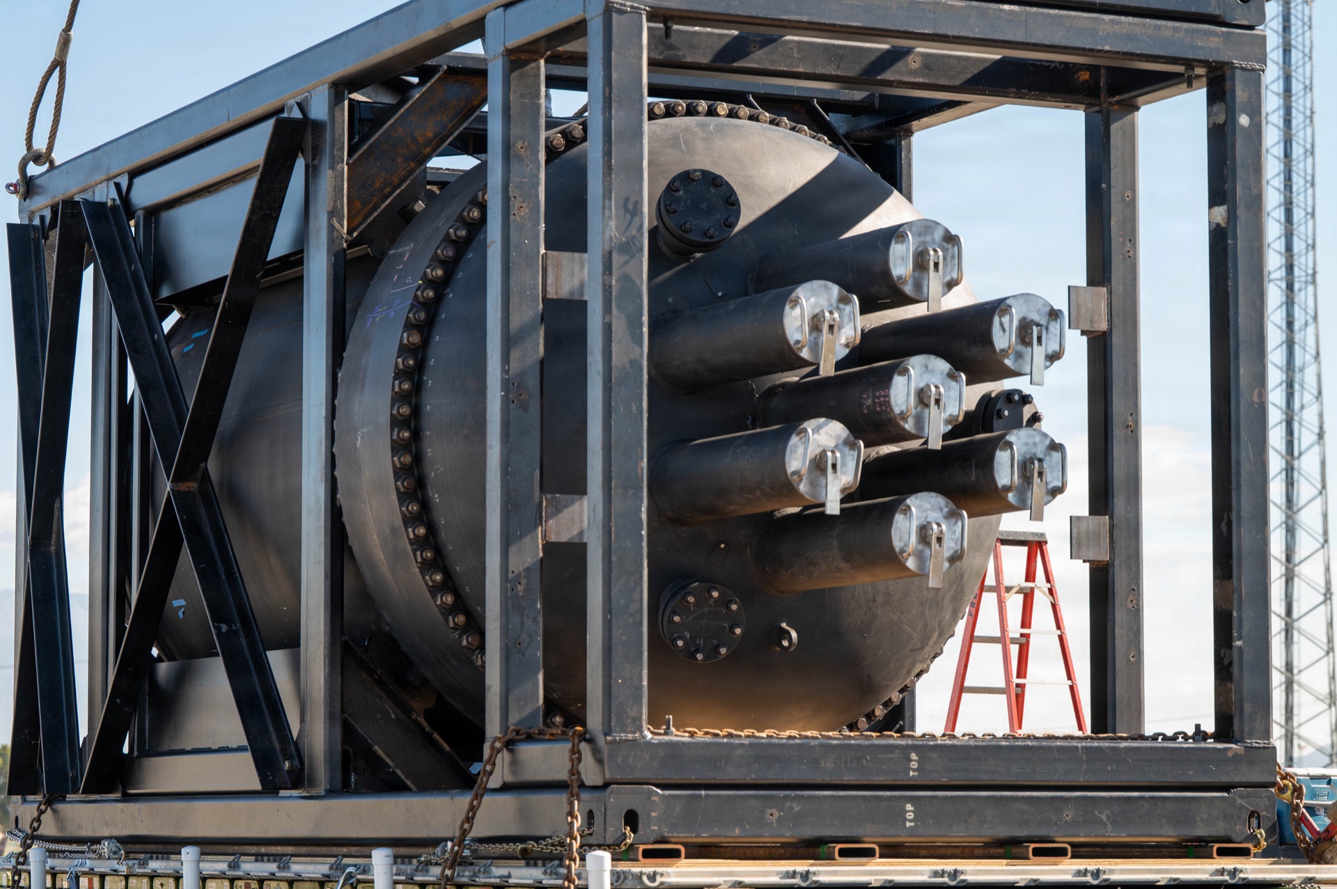 Nuclear reactor pressure vessel housed in steel transport frame at industrial facility